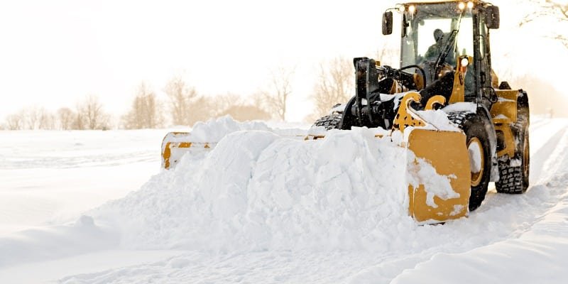Snow removal loader clearing commercial lot in Ottawa